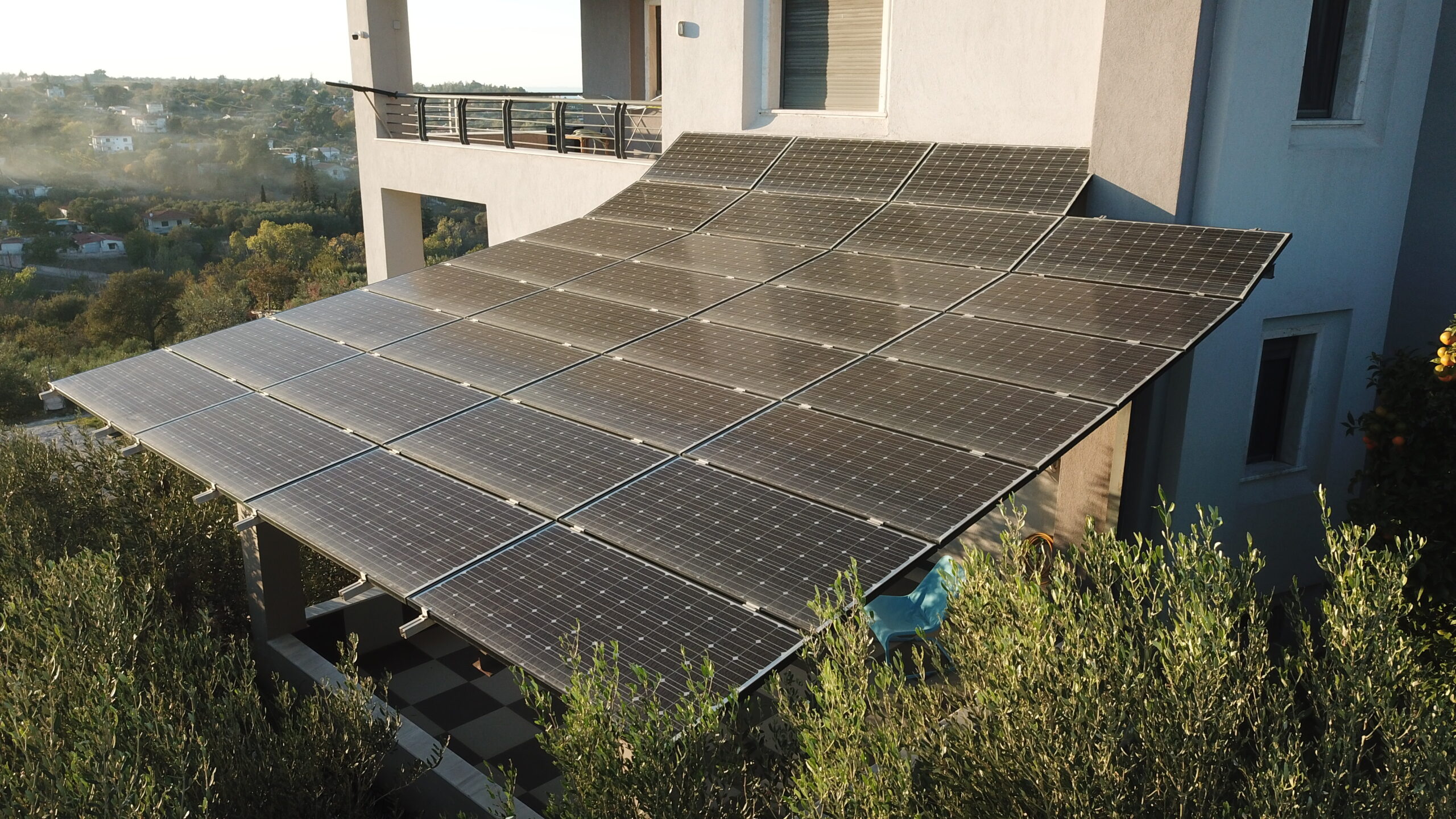 Solar panels integrated with a CPHD-certified passive house in Greece, showcasing Dynamiki ATE’s eco-friendly construction