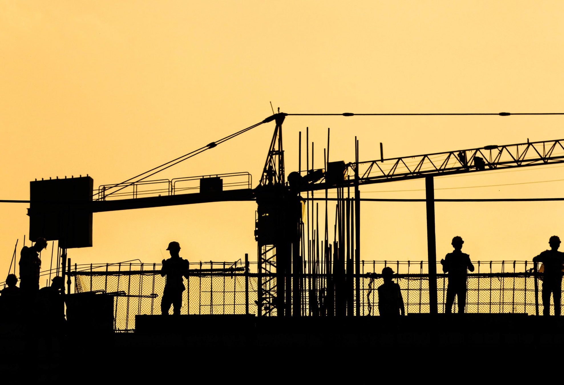 Working builders on the sunset